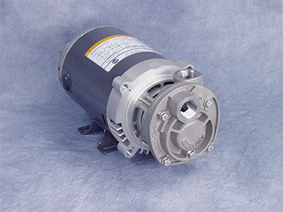 MTH's MTH 1-PHASE:T31E 1/3 HP industrial motor, featuring a silver metal exterior and circular front component, is set on a textured gray surface. An integrated bronze impeller boosts efficiency. The motor’s side displays a label with detailed information for easy identification.