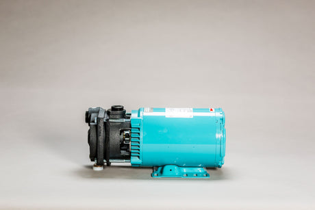 A MTH 3-PHASE:T51P 5.0 HP electric motor, in blue and black colors, featuring a bronze impeller, is displayed against a neutral background. The MTH motor is bolted onto a flat base, highlighting its cylindrical shape and mechanical components.